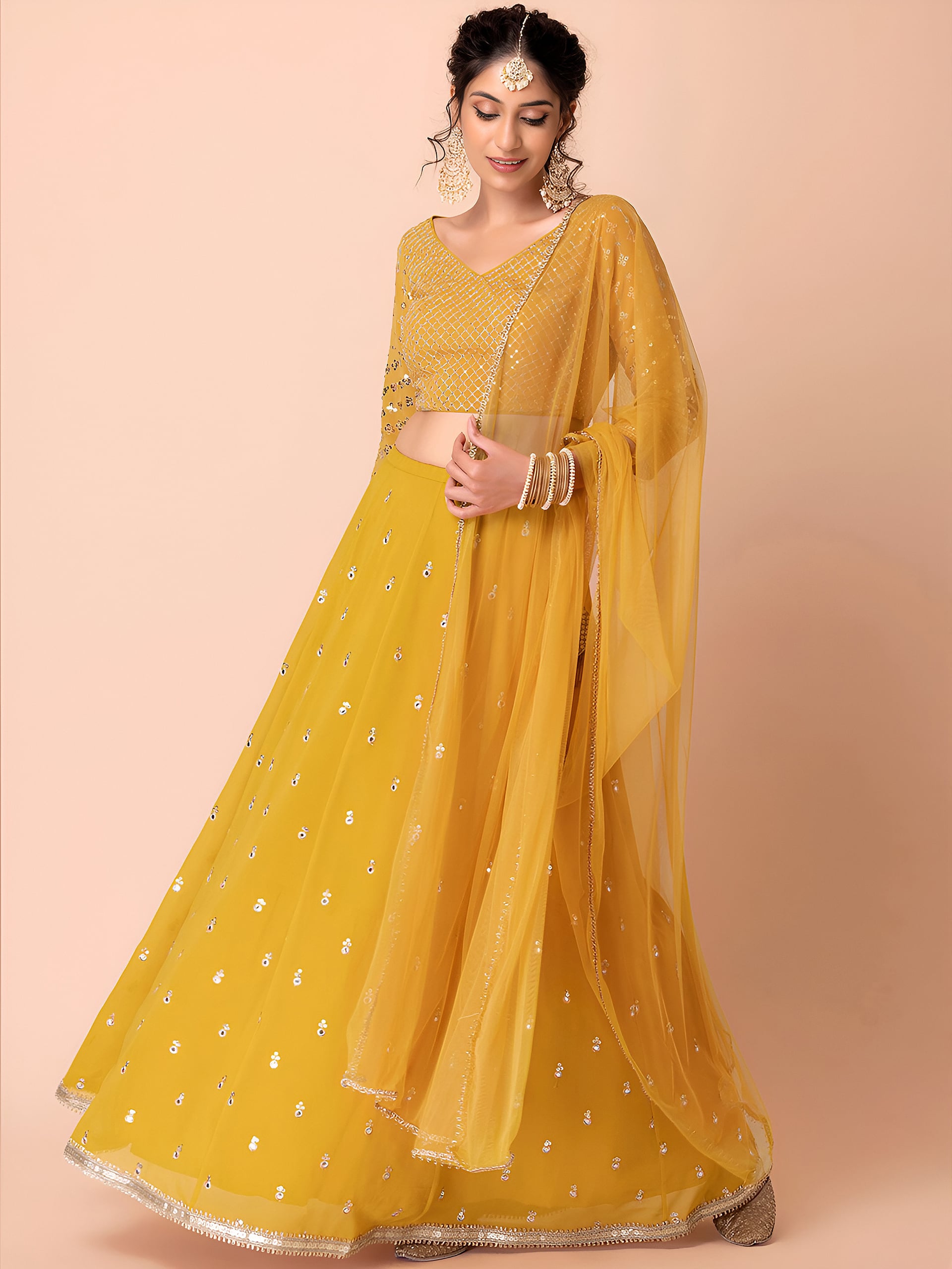 This outfit is a Black Georgette lehenga - Yellow