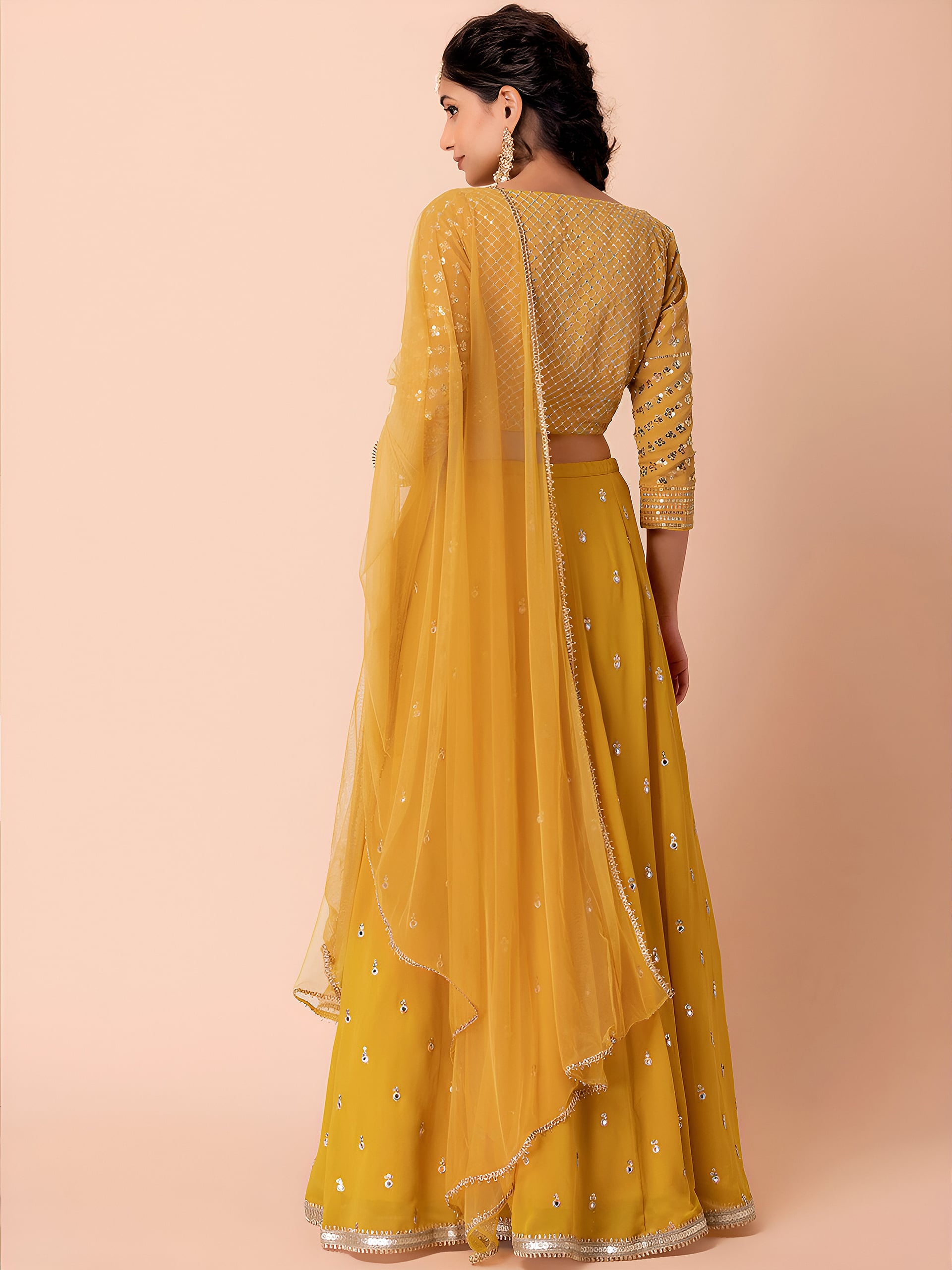 This outfit is a Black Georgette lehenga - Yellow