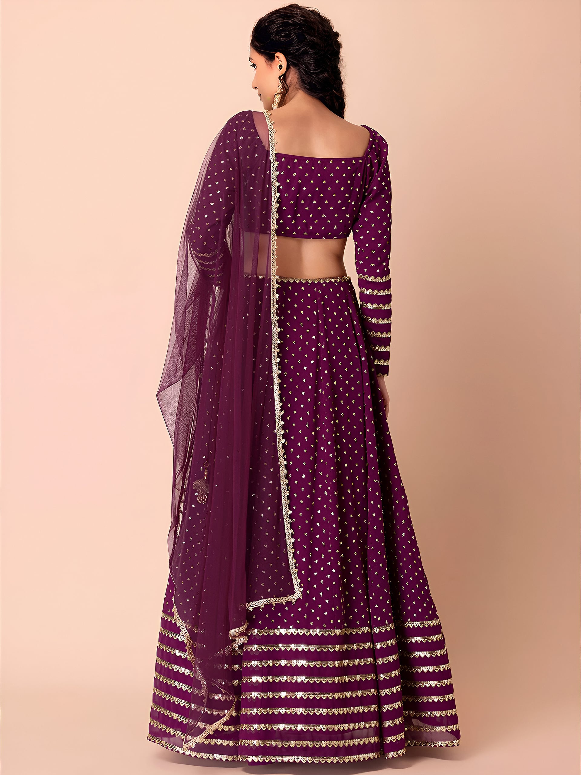 This outfit is a Black Georgette lehenga - Wine