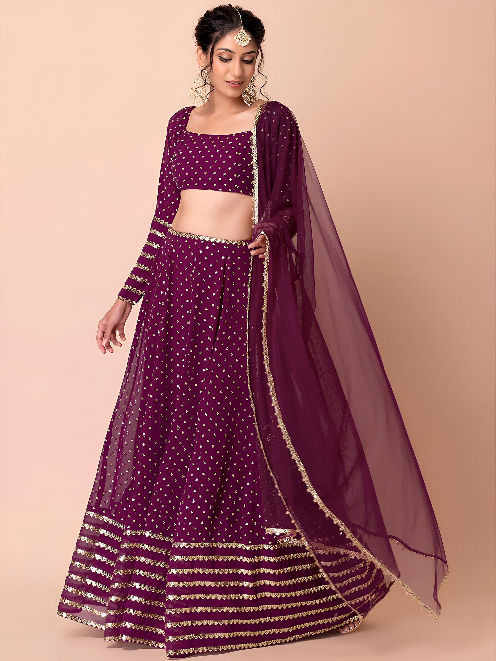 This outfit is a Black Georgette lehenga - Wine