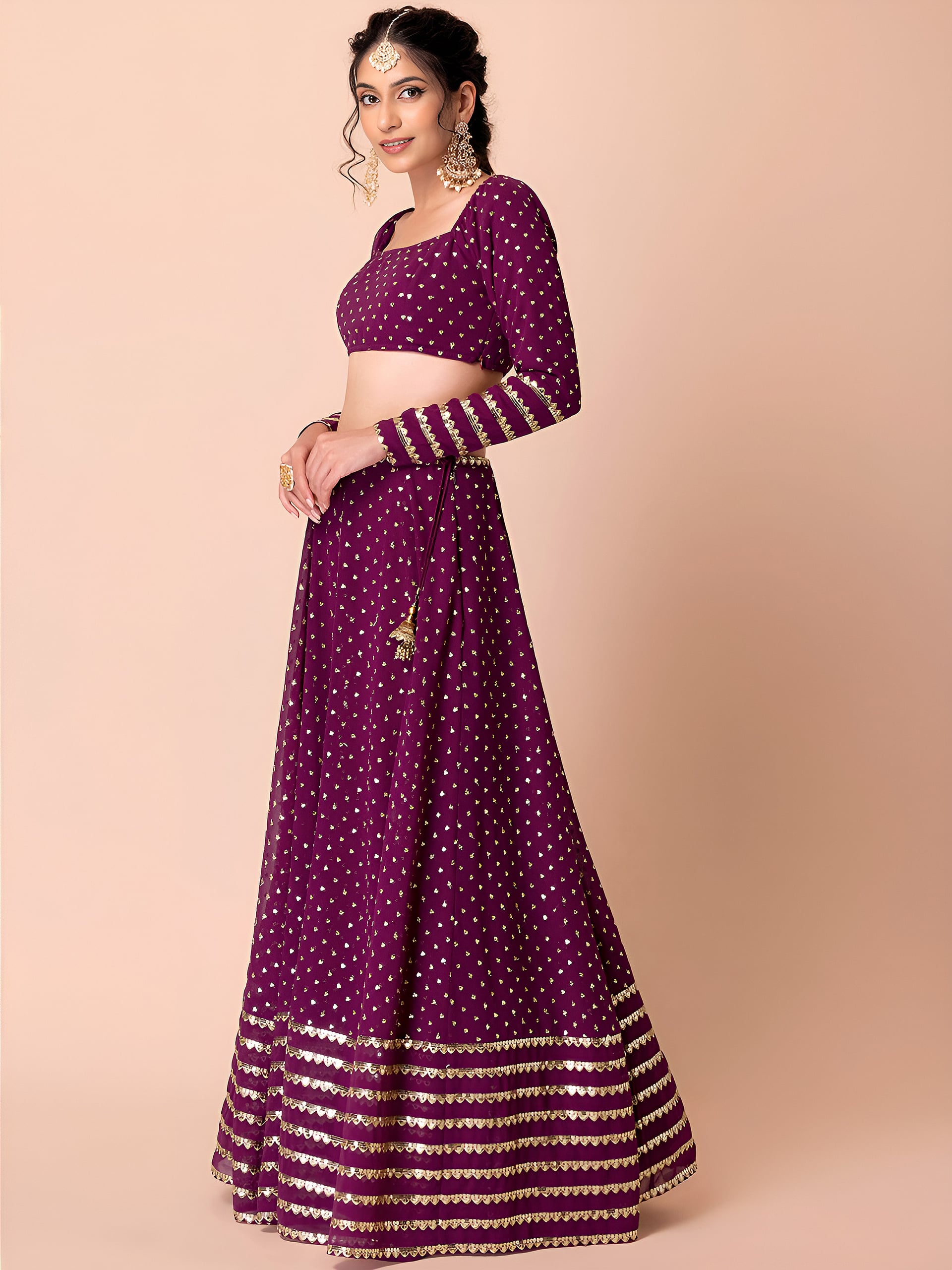 This outfit is a Black Georgette lehenga - Wine