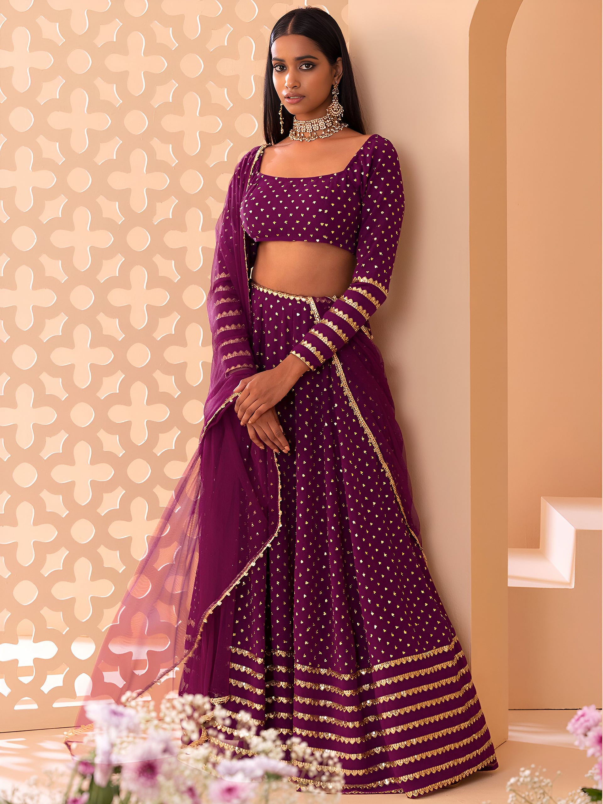 This outfit is a Black Georgette lehenga - Wine