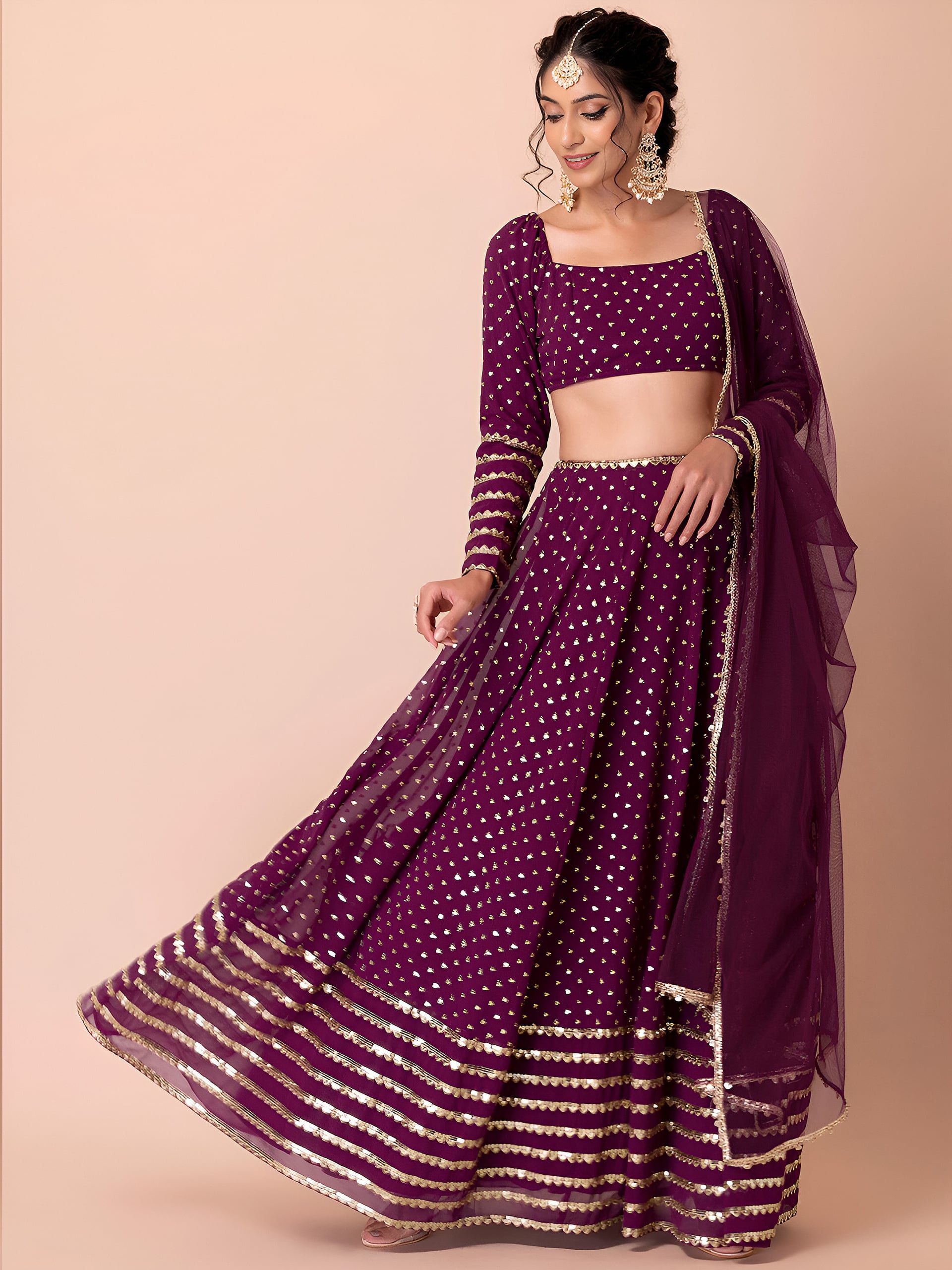 This outfit is a Black Georgette lehenga - Wine
